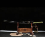 Auspicious Cloud knife, black scabbard and green hilt sword elegantly displayed on wooden stand, full view for collection.