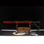 Red Dragon Guard Sword, full display with wooden stand, red scabbard with black patterns, dragon head handle detail, collectible samurai sword