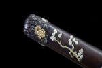 Premium Tanto handle mid-section, revealing elegant golden menuki beneath wrapping.