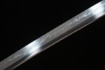 Snow Lotus Warrior blade close-up, revealing intricate forging pattern, demonstrating superior craftsmanship.