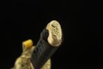 Emperor's Golden Blade handle end golden pommel close-up, showcasing intricate floral patterns and luxurious details