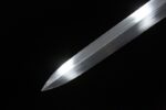 Knight sword, close-up of sharp silver tip, showcasing its sharpness and exquisite craftsmanship.