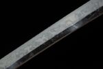 Double Dragon Sword blade mid-section detail, showing its smooth edge and fine forging marks, highlighting craftsmanship.