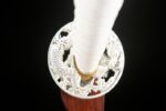Little White Dragon Wakizashi, close-up of the white openwork tsuba, featuring intricate dragon carvings, seamlessly connected to the white ito-wrapped hilt, showcasing exquisite craftsmanship and unique design.