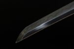Toyama Dragon Sword sharp blade tip close-up, showcasing its fine cutting edge profile and forging texture