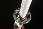 Snow Lotus Warrior handle and Tsuba guard overall view, white wrapping harmonizing with gold Tsuba, aesthetic and practical.