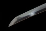 Longhai Katana blade close-up, highly polished surface reflecting light, highlighting sharp cutting edge.
