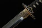 Toyama Dragon Sword blade, golden habaki, and tsuba close-up, showcasing precise connection and rich textures