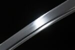 Golden Dragon Blade blade mid-section close-up, significant mirror polish effect, reflecting light, superior texture