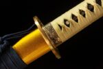 Double Dragon Sword handle gold wrapping close-up, showing its tightly braided texture, providing secure grip.