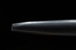 European sword, close-up of black scabbard end, featuring leather texture and rounded tip, ideal for product display.