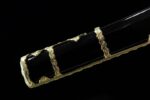 Half-Tachi scabbard mid-section, black lacquer with gold floral decoration, showcasing unique style.