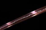 White Lotus Knife blade mid-section detail, showing clear forging pattern and high sheen, highlighting blade quality.