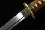 Golden Dragon Blade golden tsuba and habaki close-up, showcasing fine carving and blade connection craftsmanship