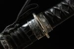 Mo Yulong Knife, close-up of the hilt and scabbard junction, showcasing the seamless transition from the black ito wrap and engraved silver fittings to the saya, highlighting the katana's intricate connection craftsmanship.