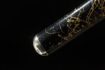 Mo Yulong Knife scabbard end close-up, showcasing its gold decoration joining the black scabbard section, finely crafted.