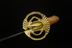 Fortune-bringing Sword round Tsuba guard close-up, featuring elegant gold openwork pattern, symbolizing good fortune.