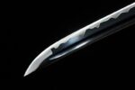 Tenmoku Japanese sword blade tip close-up, revealing clear hamon and sharp edge line