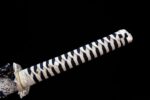 White Lotus Knife hilt full view, intricately wrapped in blue and white cotton ito forming a distinct diamond pattern, showcasing its elegant style and grip.