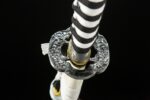Mermaid Sword circular tsuba top view, highlighting exquisite golden carving and structure
