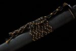 Shadow Ninja Straight Blade, close-up of the black scabbard with a unique black and gold sageo knot, showcasing the saya's texture and the intricate knot craftsmanship.
