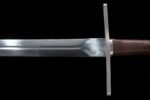 Brown European Sword blade base close-up, details at the guard connection