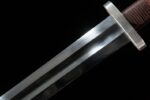 Wind Messenger sword, close-up of metal blade and leather hilt connection, showcasing guard design and robust construction.