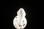 Little White Dragon Wakizashi handle pommel silver engraving detail, showcasing delicate floral and dragon patterns.