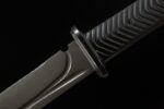 Bass Desert Judge handle grip close-up showing textured rubber overmold, tactical knife, desert hunting knife