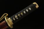 Emperor's Golden Blade handle black wrapping and golden decoration details, showcasing the grip's exquisite craftsmanship and texture