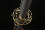 Longyao Kyushu Japanese sword handle and tsuba close-up, golden menuki with black wrapping