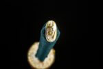 Green Shade Katana, close-up of the green ito wrap termination and golden kashira fitting, intricately carved with a floral motif, showcasing exquisite handle craftsmanship.