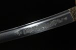 Golden Dragon Blade blade mid-section dragon carving detail, flowing lines, lifelike representation.