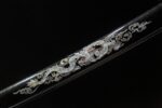 Salo knife scabbard mid-section, black glossy saya with ornate white and gold dragon and cloud patterns. Enhances sword's aesthetic.