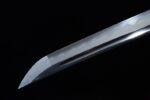 Half-Tachi sharp blade tip close-up, showcasing its highly polished surface and precise cutting angle, highlighting sharpness.