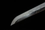Double Dragon Sword sharp blade tip close-up, showcasing its highly polished surface and precise cutting angle, highlighting sharpness.