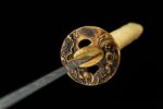 Double Dragon Sword round Tsuba guard close-up, showcasing double dragon openwork carving and gold details, symbolizing auspiciousness.