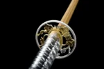 Silver Peony fuchi collar and tsuba guard floral motif close-up on samurai sword
