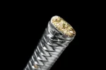 Silver Peony pommel (kashira) close-up showing gold peony floral engraving on silver metal, samurai sword, ornamental sword
