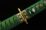 View of the Blue Water Knife handle with green wrap and gold-finished guard.
