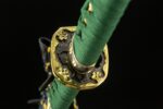 Close-up of the Blue Water Knife handle guard, showcasing its gold accents and fine detailing.