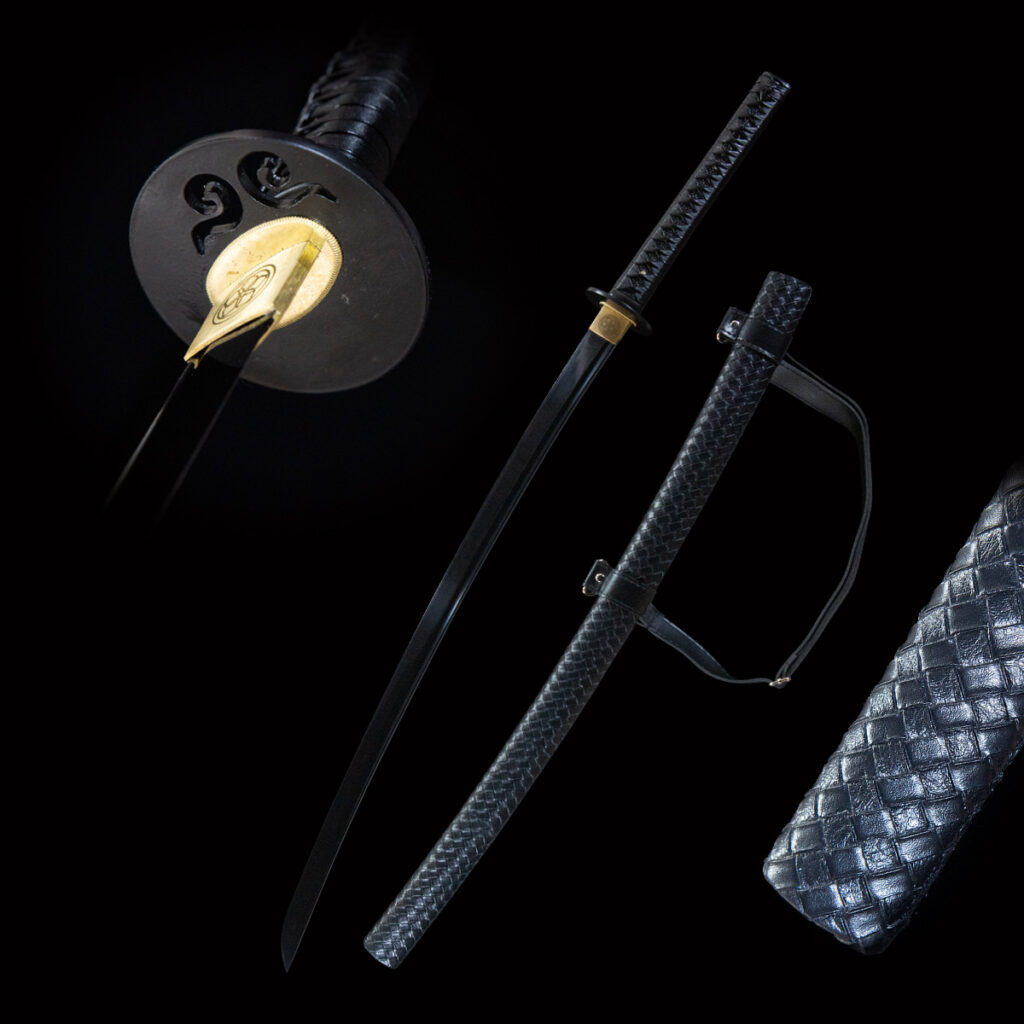 Pure black sword with ornate hilt, full blade, and leather-wrapped scabbard