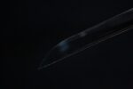 Pure black sword close-up of the blade tip