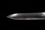 Qin Wang Sword blade tip, showcasing the sharp edge and Damascus pattern.