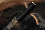 Chibi Xiaohan Sword, a close-up of the hilt and guard, emphasizing the carved craftsmanship of the metal fittings.