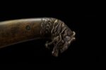 Mongolian knife handle end, close-up of the three-dimensional dragon head shape