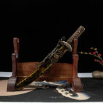 Gold Dragon Wakizashi displayed on wooden stand with scabbard
