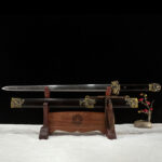 Qilin Sword, displayed on a wooden stand, showcasing the full blade and scabbard with a classic design.