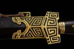 Qin Wang Sword scabbard and guard joint, showcasing the intricate gold meander pattern and connection point.