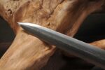 Chibi Xiaohan Sword, a close-up of the sharp tip, highlighting the blade's forging craftsmanship and edge texture.